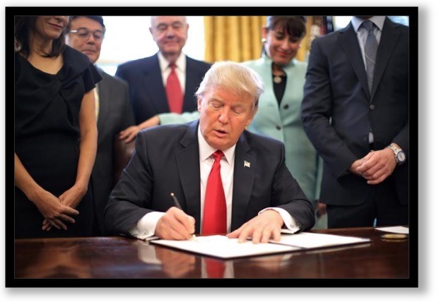 President D J Trump signs a piece of paper saying no business regulations and stuff.